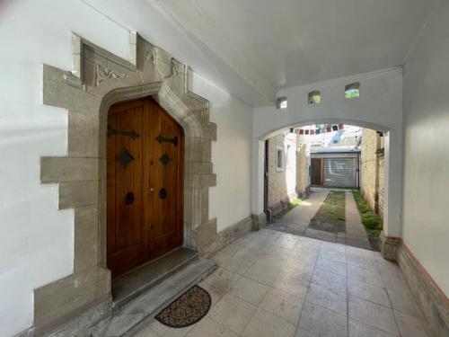 a hallway with a wooden door in a house at Casa Torino in Santiago