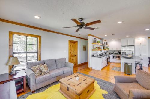 a living room with a couch and a table at The Bird Cabin Peaceful Refuge in East Texas in Ben Wheeler