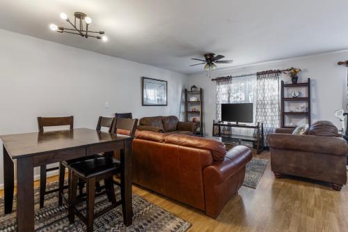 a living room with a couch and a table at 7 minutes to IAD upstairs room in DC Metro area Middle size room in Sterling