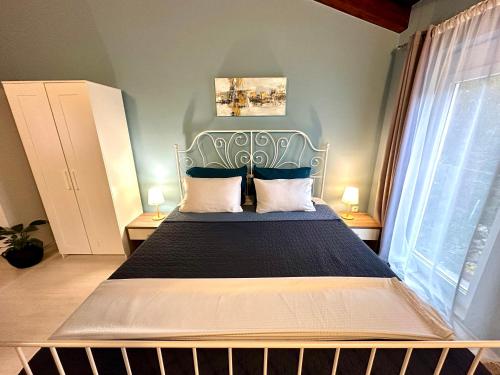a bedroom with a large bed with a blue headboard at Haus Stepcich in Plomin