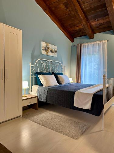 a bedroom with a large bed and a window at Haus Stepcich in Plomin