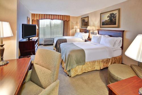 a hotel room with two beds and a television at Holiday Inn Hotel & Suites Ann Arbor University of Michigan Area by IHG in Ann Arbor