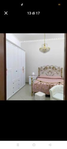 a bedroom with a bed and a sink and a chandelier at Suit catania1946 in Catania