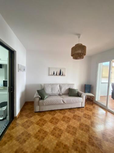 a living room with a couch on a wooden floor at Despierta frente al mar en Moaña in Pontevedra