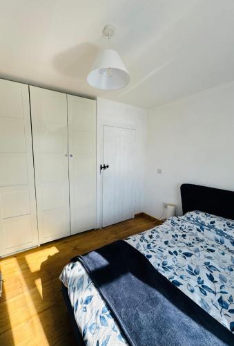 a bedroom with a bed and white cabinets at 3 bedroom cottage Brecon sleeps 4 in Brecon