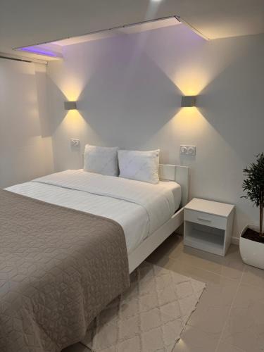 a bedroom with a bed with lights on the wall at Appartement Love in Bussières-lès-Belmont