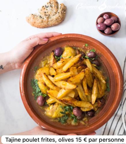 a person holding a bowl of food with french fries at Appartement Love in Bussières-lès-Belmont
