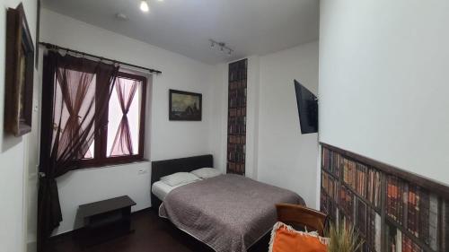 a bedroom with a bed and a window at Lorf Hostel&Coffee in Kraków