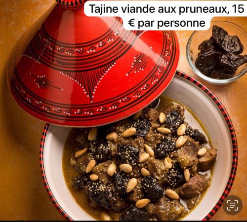 a red bowl of food with nuts in it at Appartement Love in Bussières-lès-Belmont