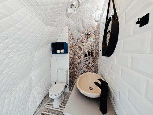 a small bathroom with a toilet and a sink at Beachwood Camps Bay in Cape Town