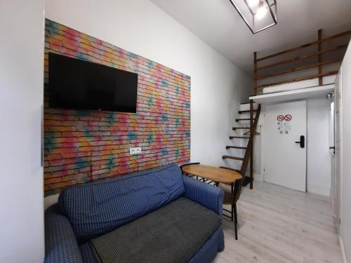 a living room with a couch and a colorful wall at Lorf Hostel&Coffee in Kraków