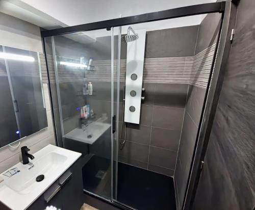 a bathroom with a shower and a sink at Gibraltar Sun Poolside Escape in Gibraltar