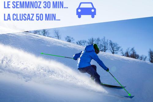 a person is skiing down a snow covered slope at Appartement chaleureux à Sévrier in Sévrier