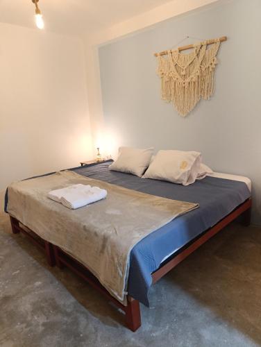 a bedroom with a large bed with two towels on it at Hospedaje Velilu in Ica