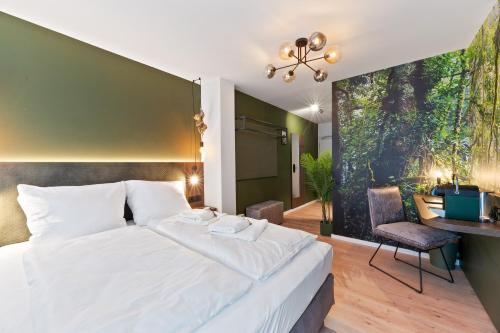 a bedroom with a large white bed and a desk at JUNGLE No5 Boutique Hotel - Stuttgart City-Center in Stuttgart