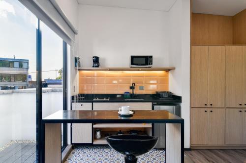 a kitchen with a table in the middle of a room at Nova Apartments in Bogotá
