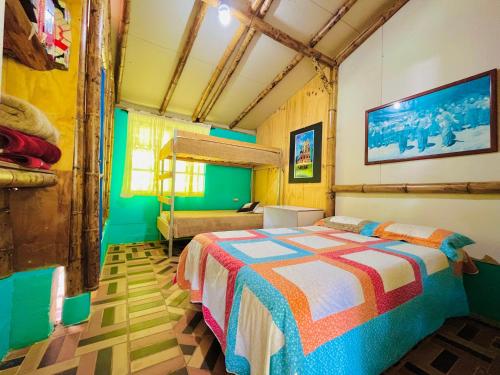 a bedroom with a colorful bed in a room at Los Gulungos Hostel in Jardin
