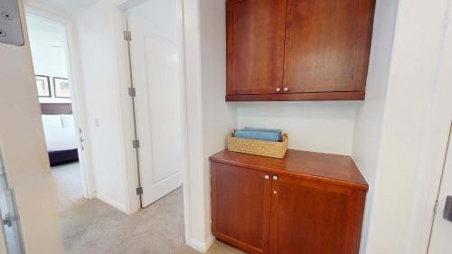 a kitchen with a wooden cabinet and a hallway at LV214 Convenient Downstairs 2 Bed Legacy Villa in La Quinta