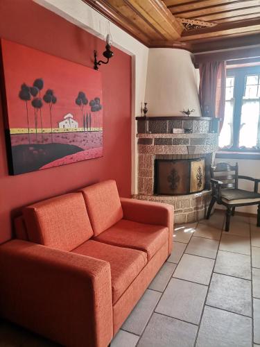 a living room with a couch and a fireplace at Konstantinou & Elenis in Monodendri