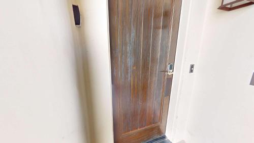 a wooden door in a hallway next to a wall at LV214 Convenient Downstairs 2 Bed Legacy Villa in La Quinta