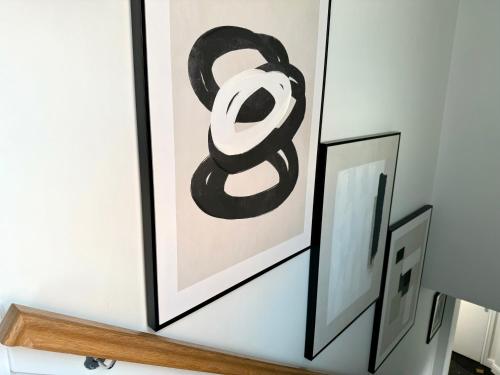 a framed picture of the number eight on a wall at 3 bed flat in Holmes Chapel Harry Styles village in Holmes Chapel