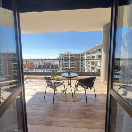 a patio with a table and chairs on a balcony at Mamma Mia House Fiumicino in Fiumicino Airport