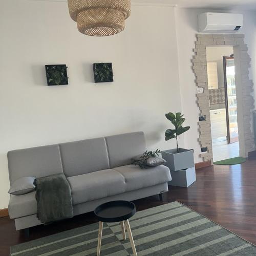 a living room with a couch and a rug at Mamma Mia House Fiumicino in Fiumicino Airport