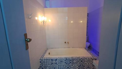 a bathroom with a bath tub in a room at Hotel e Pousada O Casarão in Palmeiras