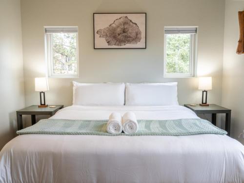 a bedroom with a bed with two lamps and two slippers at Mountain Serenity Retreat in Florissant