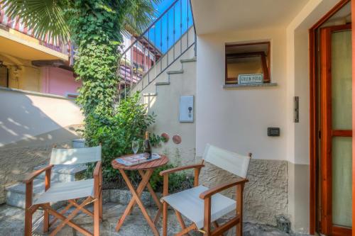 a patio with chairs and a table and a staircase at La Piccola Casa Dell'Uva Fragola - Happy Rentals in Meina