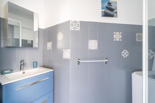 une salle de bain avec un lavabo, des toilettes et un miroir dans l'établissement Appartement Le Kid, à Sanary-sur-Mer