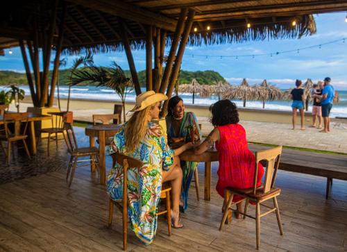 three women sitting at a table near the beach at Villa #35 - Blue Venao, Playa Venao in Playa Venao