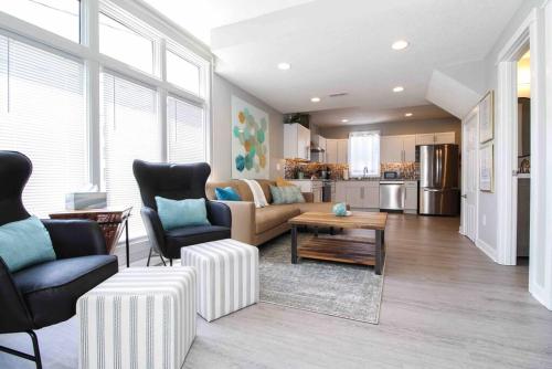 a living room with a couch and a table at Lux finishes 4 bedroom DSM home Great location in Des Moines