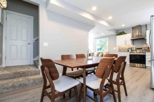a kitchen and dining room with a wooden table and chairs at Lux finishes 4 bedroom DSM home Great location in Des Moines