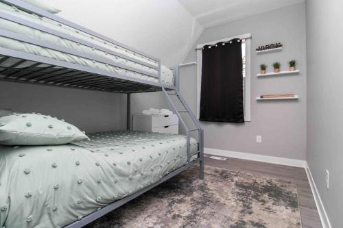a bedroom with a bunk bed and a window at Lux finishes 4 bedroom DSM home Great location in Des Moines