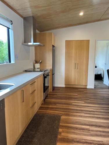 a kitchen with wooden cabinets and a counter top at Country Retreats on Ranzau 9 in Hope