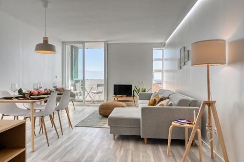 a living room with a couch and a table at Maranta House, a Home in Madeira in Funchal