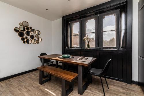 a dining room with a table and chairs and a window at Locksbrook Lodge - Hot Tub - Spacious Outdoor Space in Bath