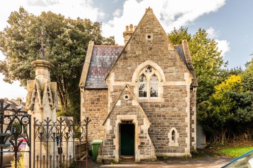 an old brick church with a green door at Locksbrook Lodge - Hot Tub - Spacious Outdoor Space in Bath