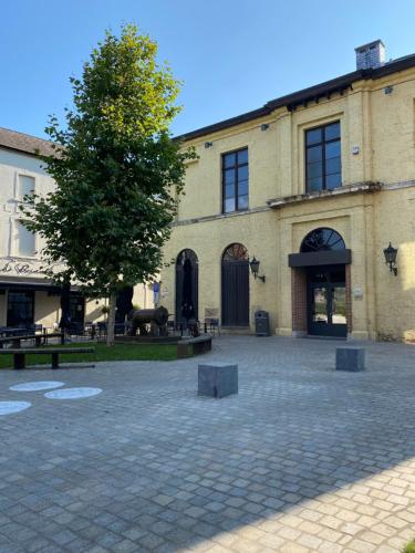 a large building with a tree in front of it at Aura Diest in Diest