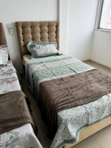 a bedroom with two beds and a window at Loft 12 Andar Praça da Bandeira com Vista in Belém