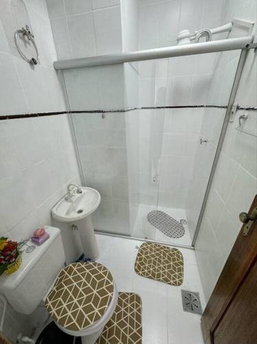a bathroom with a shower and a toilet and a sink at Loft 12 Andar Praça da Bandeira com Vista in Belém