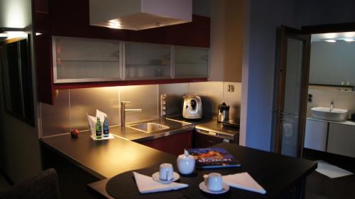 a small kitchen with a table and a counter top at Art Apartment Szczecin in Szczecin