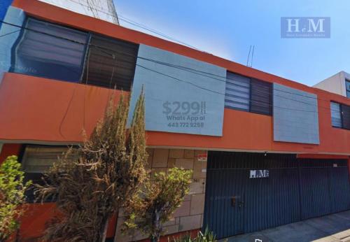 an orange building with a sign on the side of it at Hotel Económico Morelia in Morelia