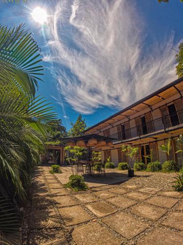 a building with a patio with a table and chairs at Hotel Casa de Hadas in Minca