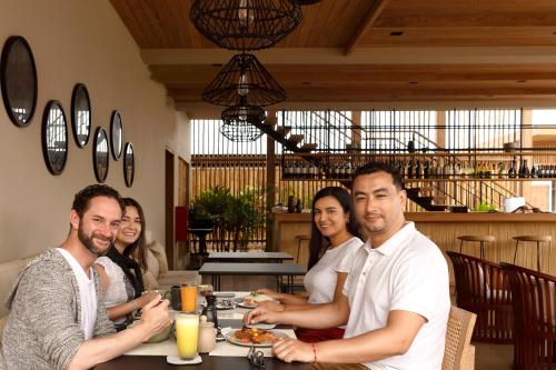 a group of people sitting at a table in a restaurant at Norte Suites Boutique in Los Órganos