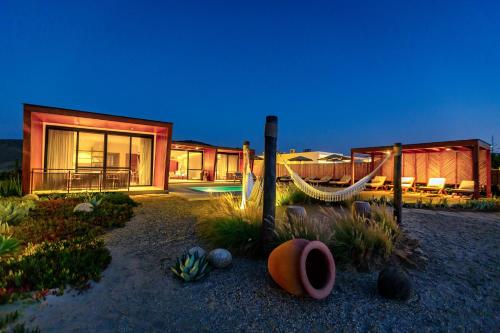 a house with a hammock in front of it at Norte Suites Boutique in Los Órganos