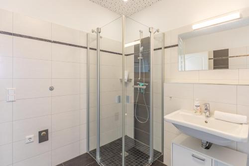 a bathroom with a shower and a sink at Carpe Diem in Husum