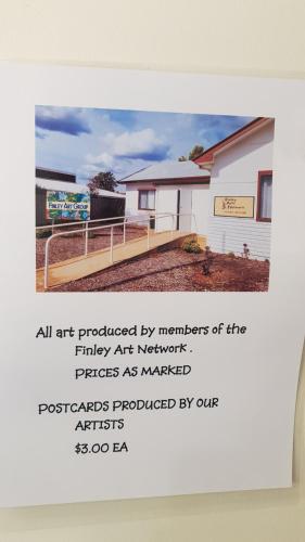 an art photograph of a white building with a sign at The Finley Palm Motor Inn in Finley
