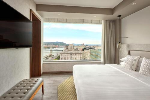 a hotel room with a bed and a large window at Budapest Marriott Hotel in Budapest